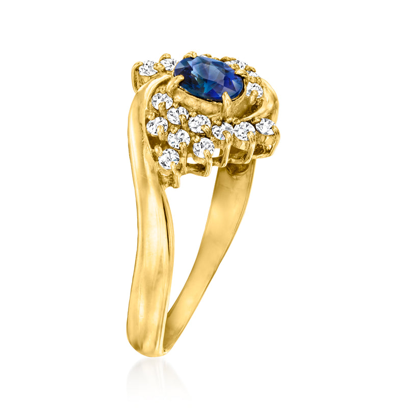 18kt yellow gold ring with oval blue sapphire top and round diamond cluster