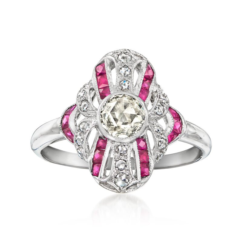 18kt white gold ring with round diamond center, pink ruby accents and ornate filigree