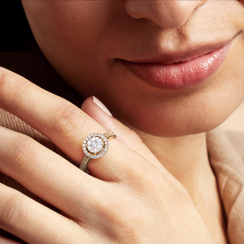 14kt yellow gold diamond cluster ring on hand, round halo center