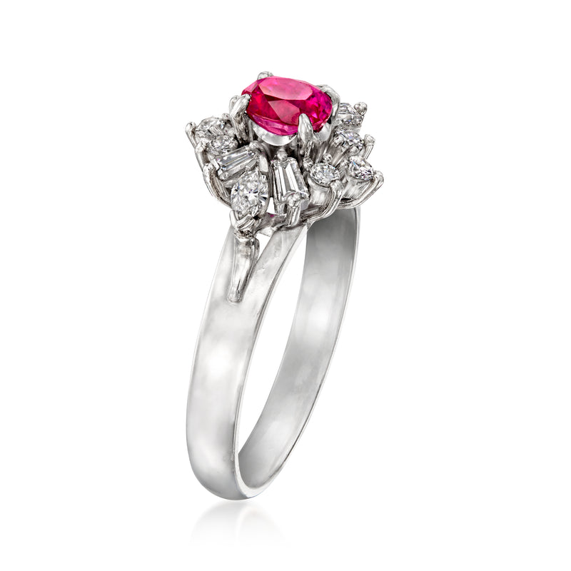 Platinum ring with oval magenta ruby center and clustered side diamond baguettes