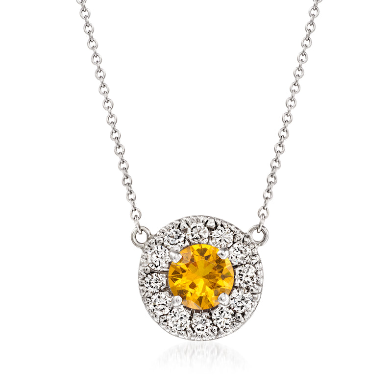 Round halo pendant necklace with yellow gemstone and diamond accents on silver chain