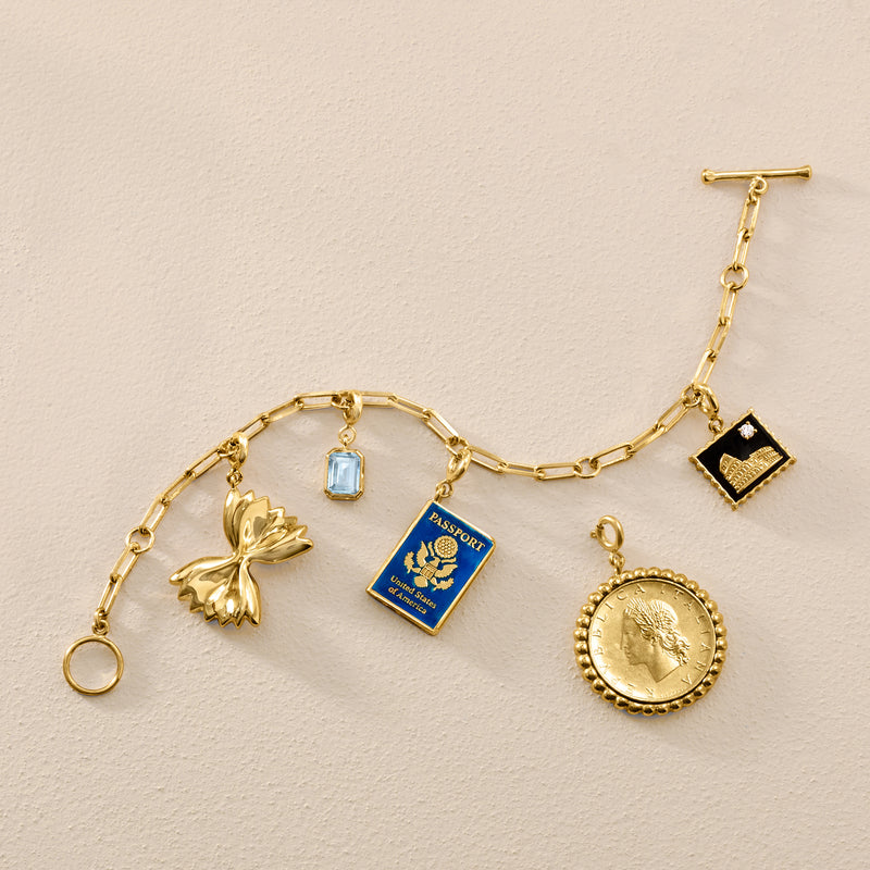 Gold chain with black Rome stamp charm pendant