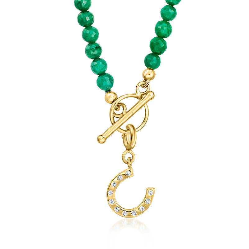 Horseshoe diamond charm pendant on green beaded necklace, close-up front