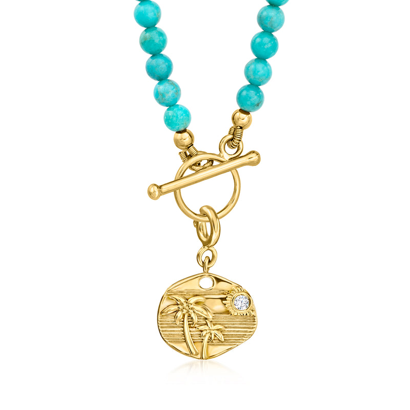 Round gold palm tropical charm with single diamond, suspended from turquoise beads