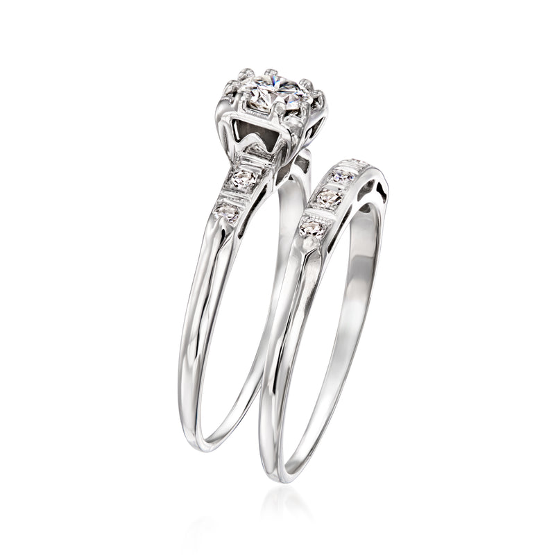 14kt white gold diamond engagement ring set, showing three stacked prongs and side stones.