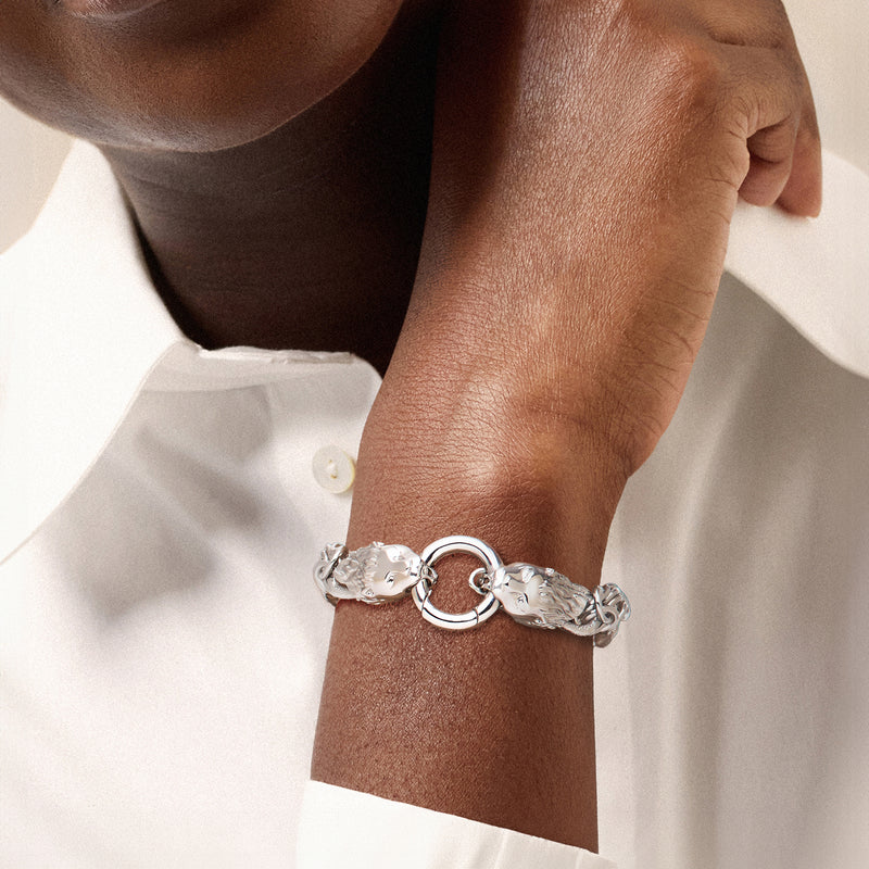 Rhodium-plated lion-head Byzantine bracelet worn on wrist with circular ring clasp