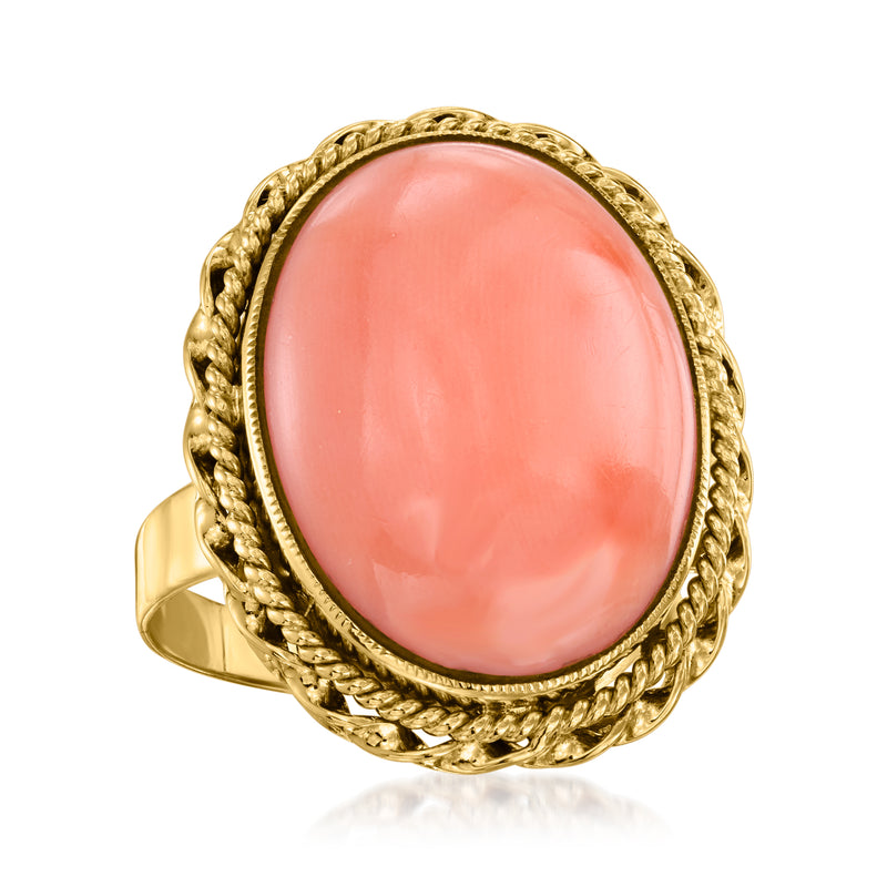 Vintage coral oval ring in 14kt yellow gold with ornate twisted braid frame