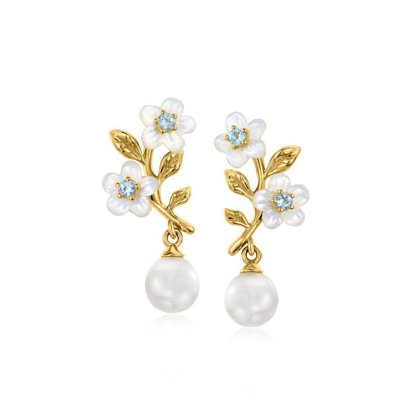 Gold drop earrings with white mother-of-pearl flowers, blue topaz centers, and pearl drops.