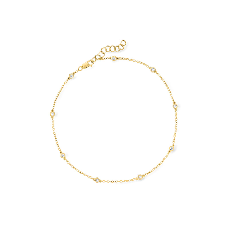 Gold-tone diamond station anklet with bezel-set round stones and a chain clasp