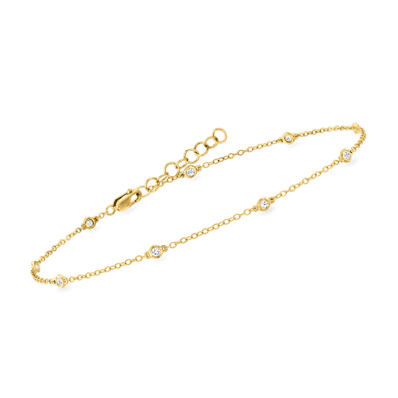 Gold-tone station anklet with round bezel-set stones and toggle clasp detail