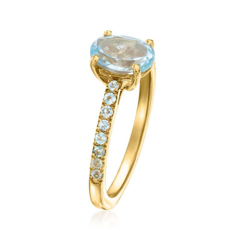 Gold ring with oval sky blue topaz and pavé blue stones