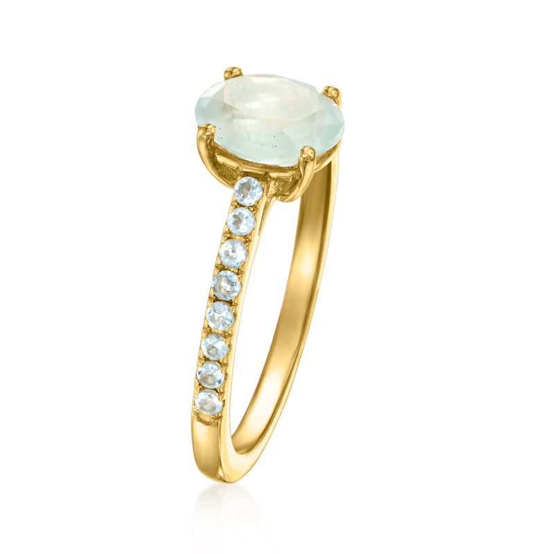 Gold ring with large oval aquamarine and five round diamond stones on the band