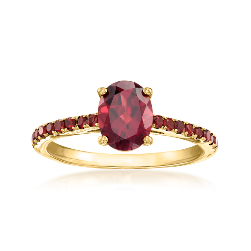 Gold ring with oval red garnet center and marquise red stones on band