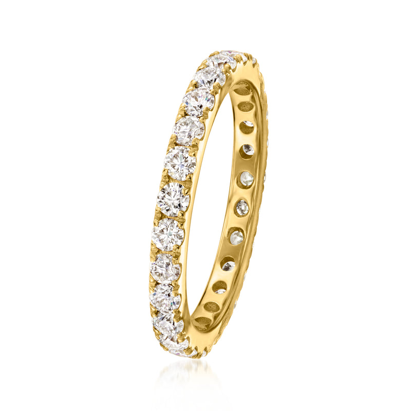 Gold moissanite eternity band with round stones along the side, open profile and prong-set look