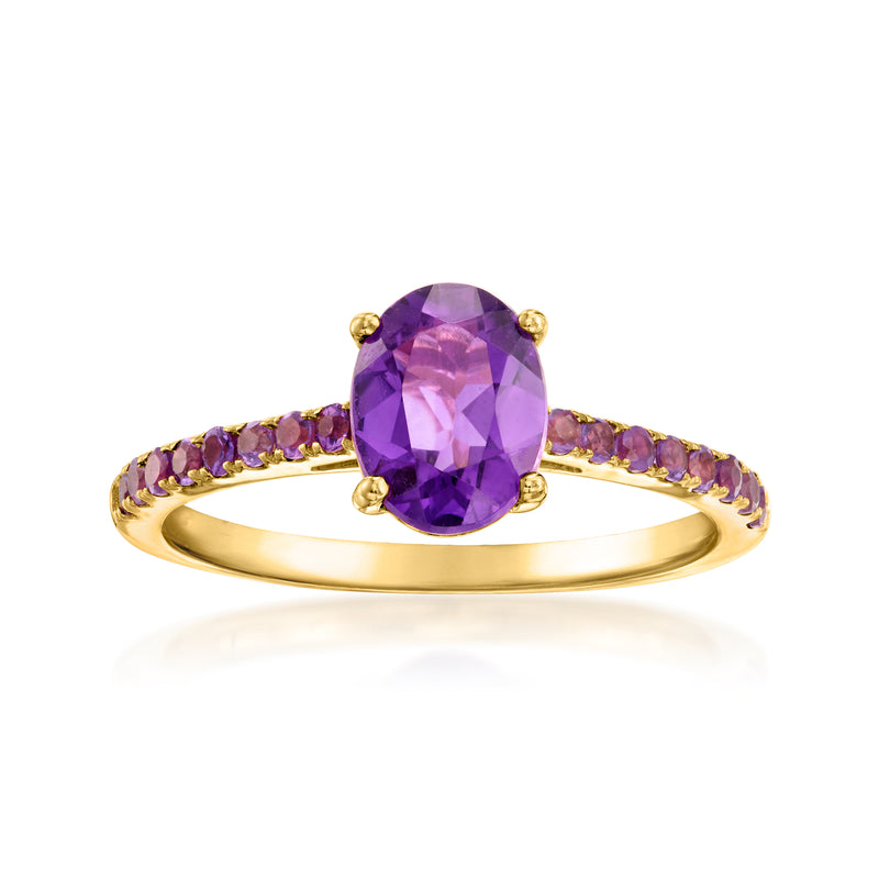 Amethyst ring with oval purple gemstone, gold band, and purple side stones