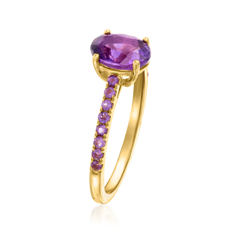 Gold amethyst ring with oval purple center stone and curved band with purple accents
