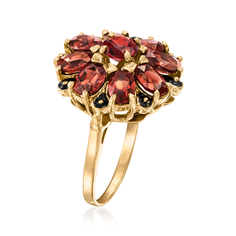 Yellow gold cluster ring with red garnet marquise and oval stones, openwork shoulders
