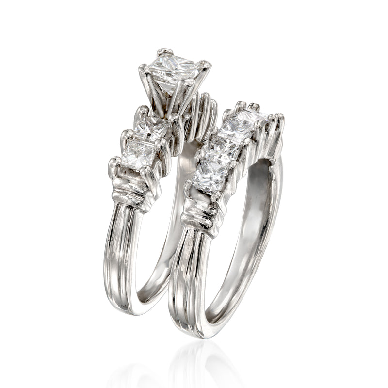 Platinum diamond bridal set with stacked open-prong bands and emerald-cut stones