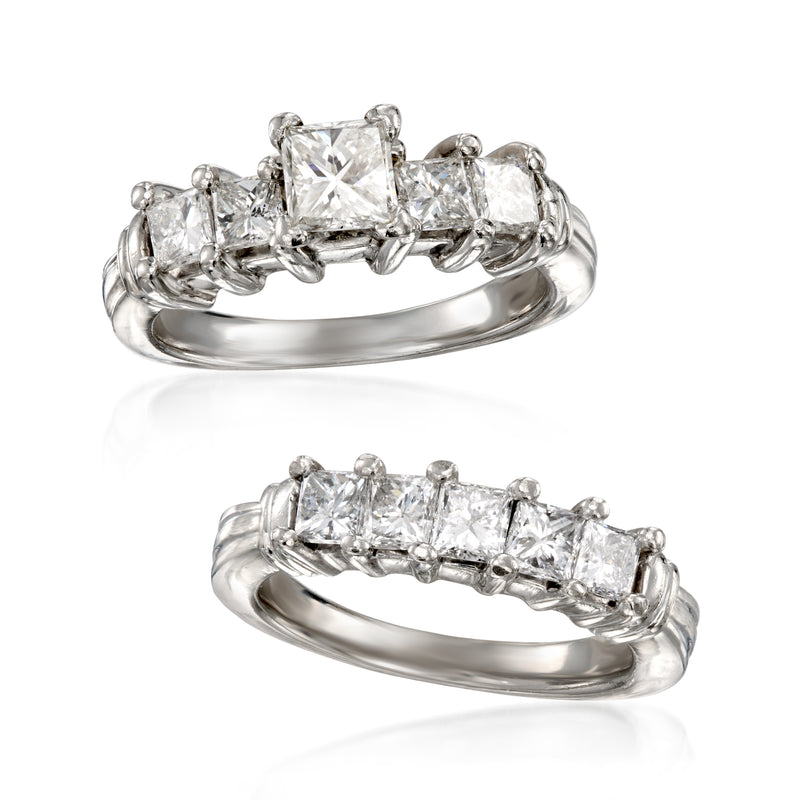 Stacked platinum diamond rings with emerald-cut center and row of smaller stones