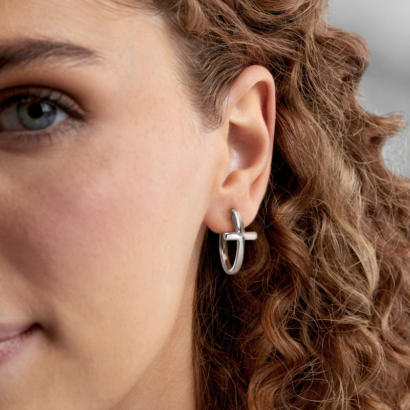 Side view: 14kt white gold hoop earrings with sideways cross charm