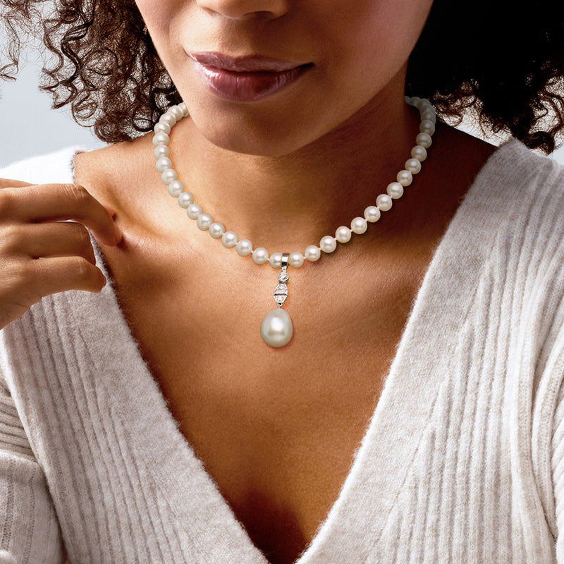 Cultured pearl pendant on diamond-accented bail, worn on pearl necklace