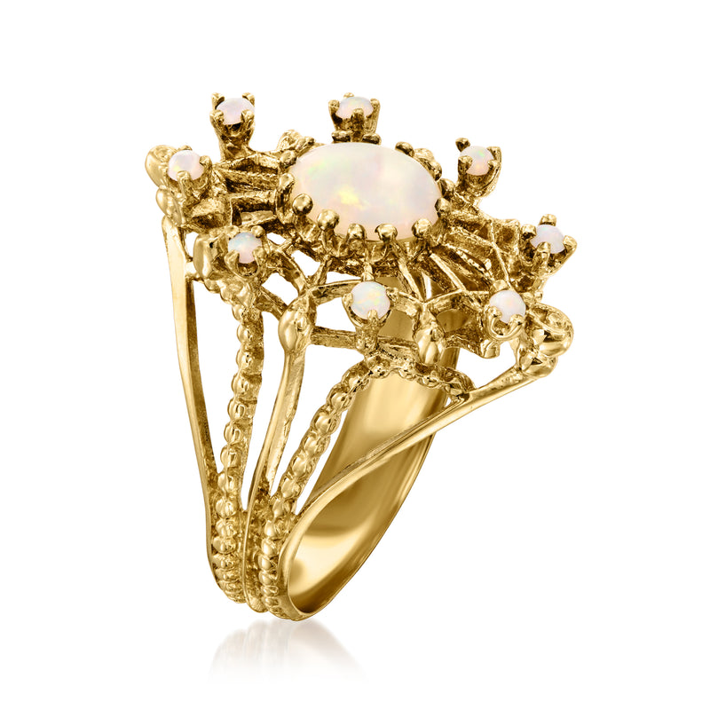 Yellow gold opal ring with oval opal centerpiece and raised lattice frame, side view