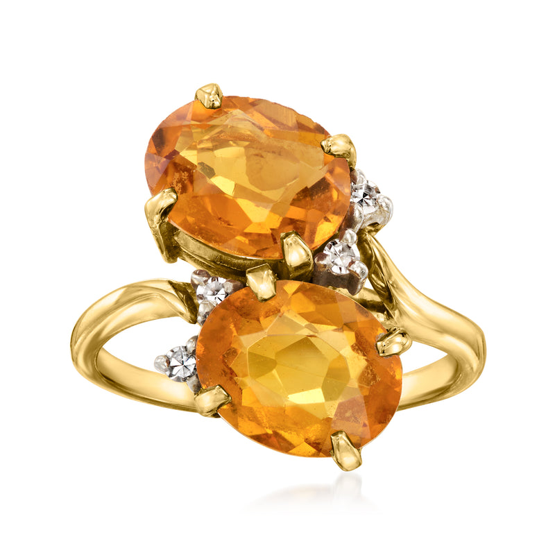 14k yellow gold bypass ring with two large oval citrine stones and diamond accents