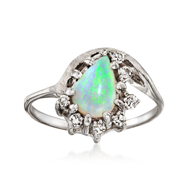 Vintage opal teardrop ring with diamond halo, set in white gold
