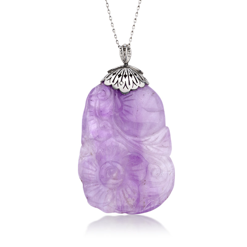 Carved purple amethyst pendant necklace with ornate black enamel cap and diamond accents
