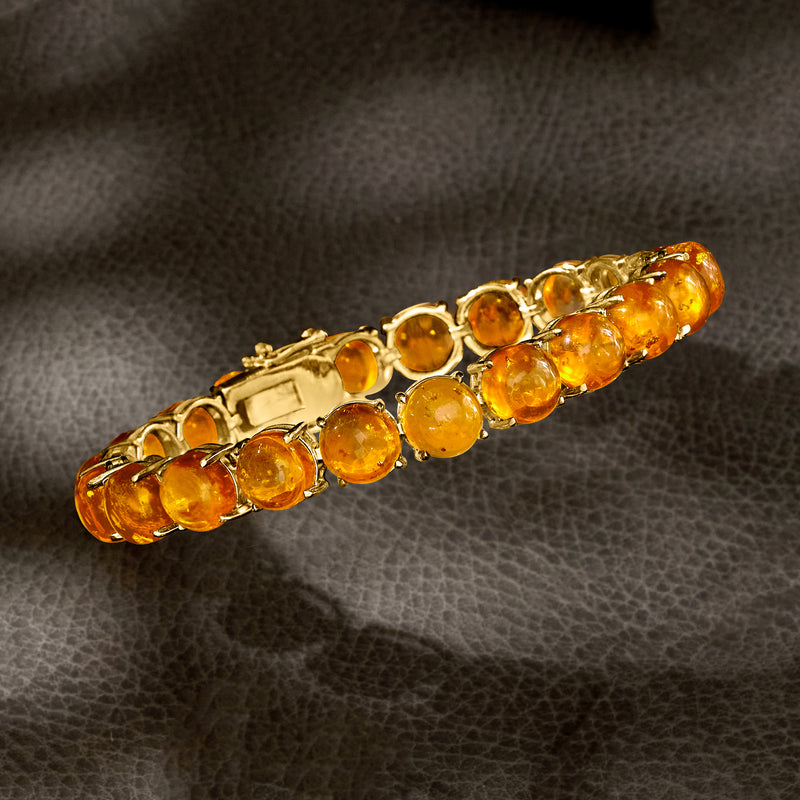 Amber tennis bracelet half view with round orange stones in gold setting