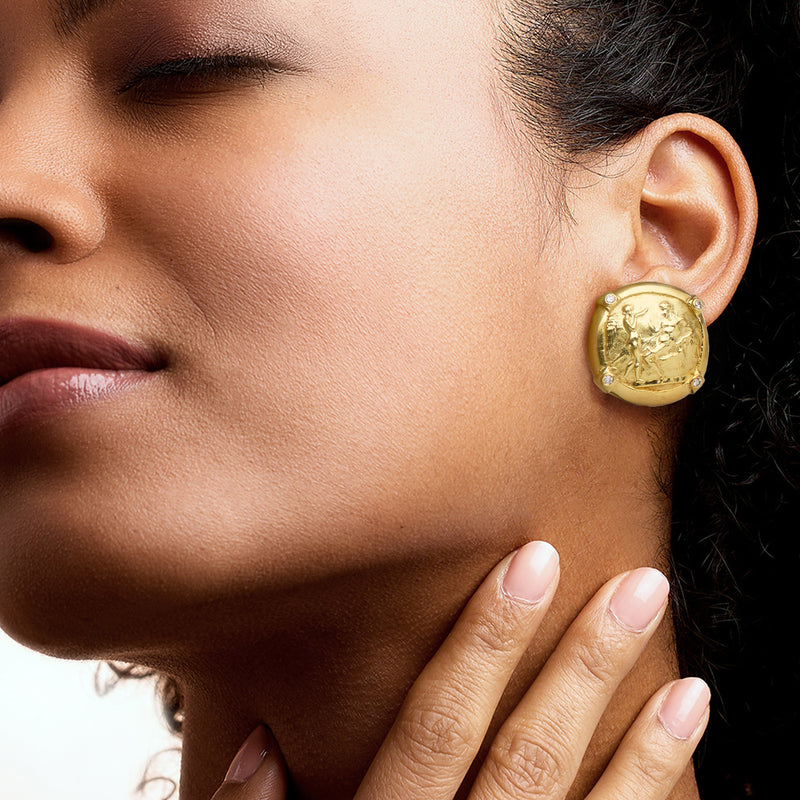 Vintage Athena coin diamond earrings in 18kt yellow gold on model's ear