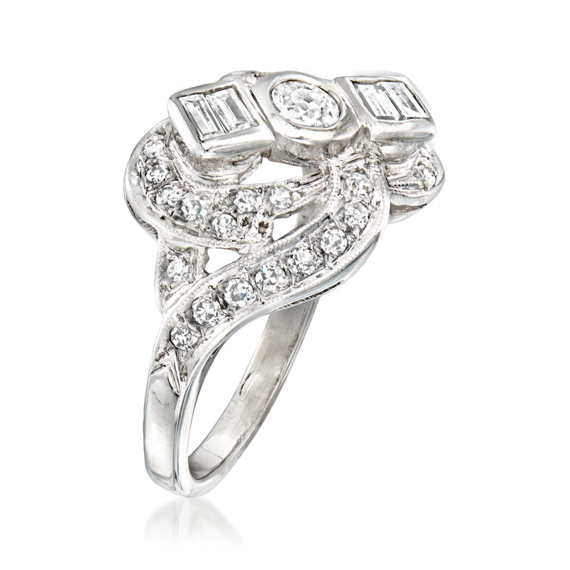 Vintage white gold diamond ring with round center, baguette accents, and side stones