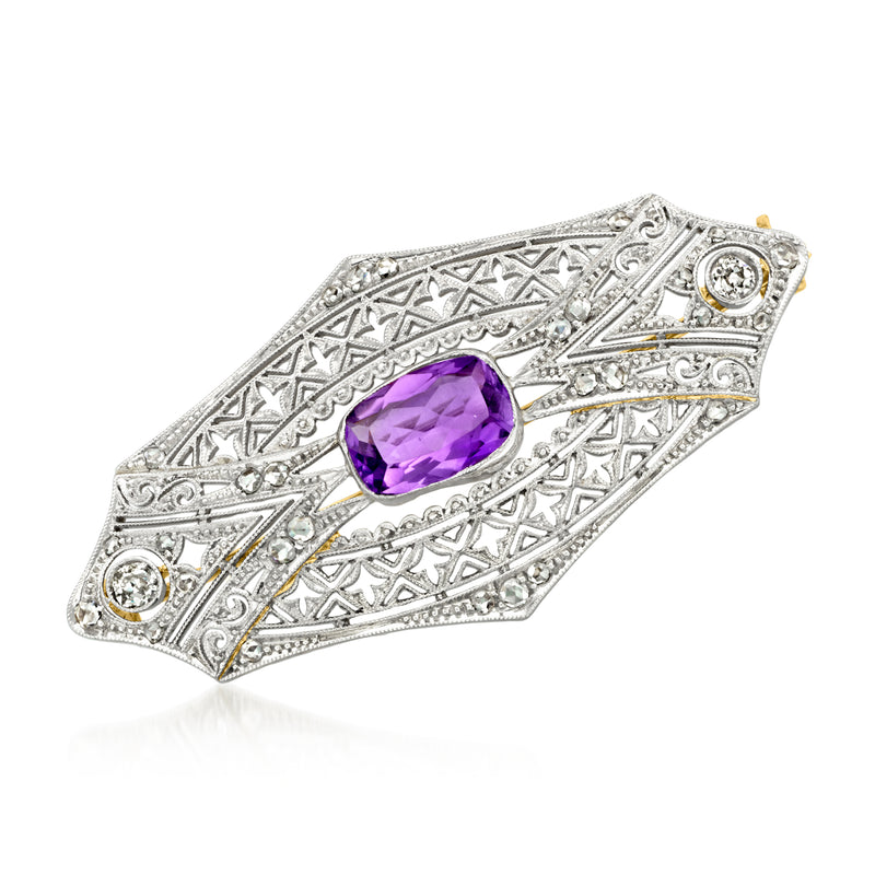 Vintage filigree pin with oval amethyst center and diamond accents on platinum setting