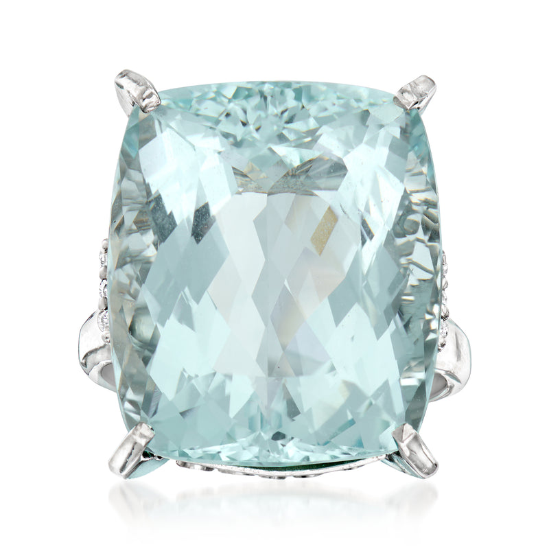 Platinum cocktail ring with large cushion aquamarine and diamond accents, side prongs