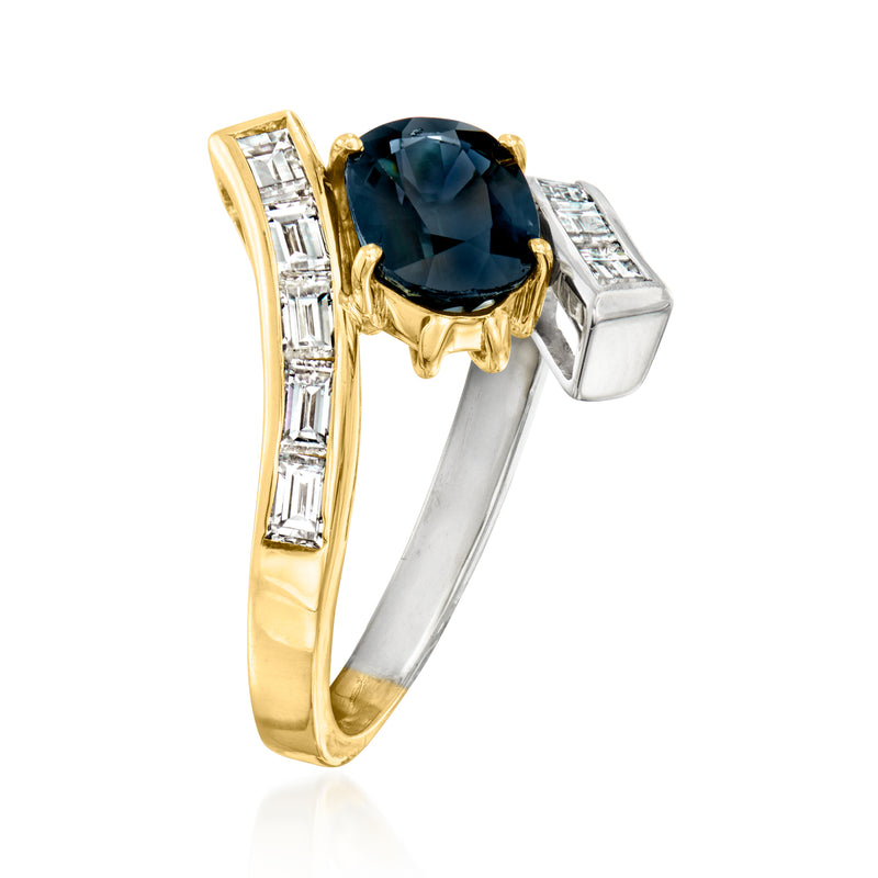 Two-tone gold ring with dark blue oval stone and baguette diamond accents, side view
