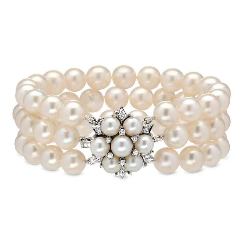 Three-row cultured pearl bracelet with diamond floral clasp, white metal setting.