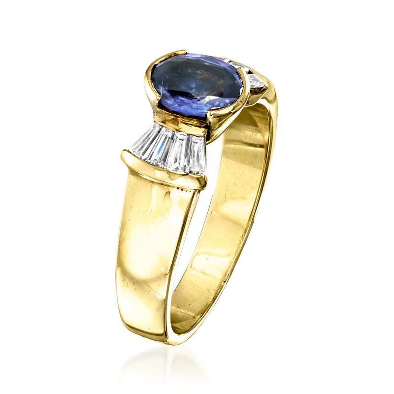 Yellow gold ring featuring oval blue sapphire with baguette diamond side settings