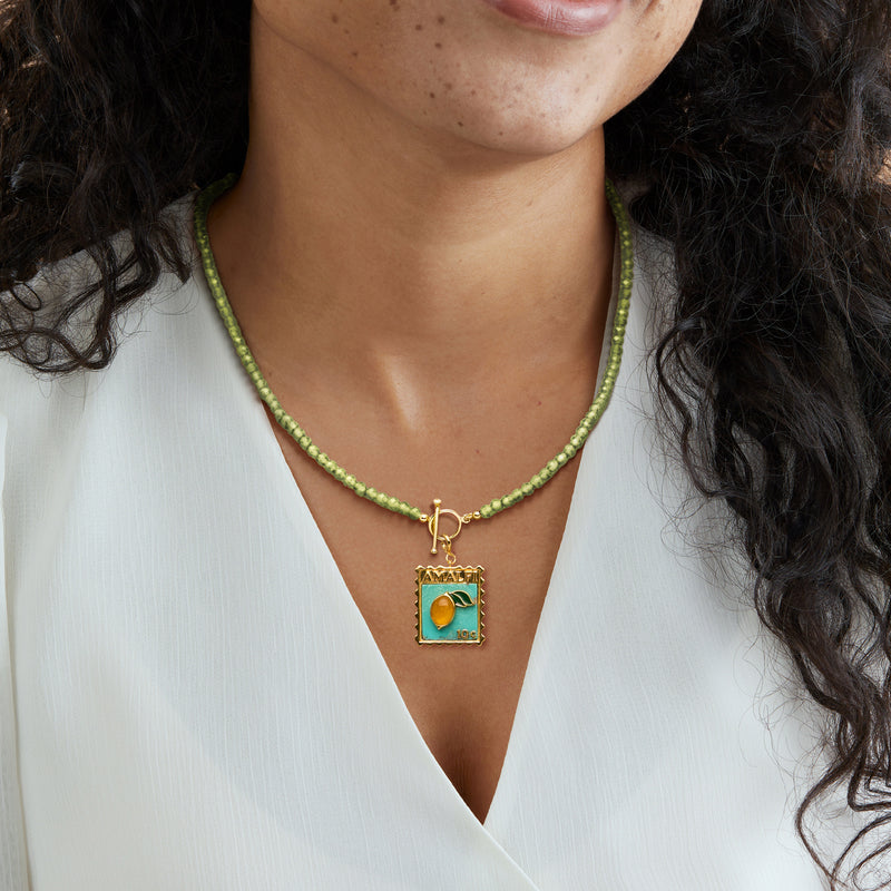 Amalfi pendant charm on green bead necklace with gold bail and turquoise enamel