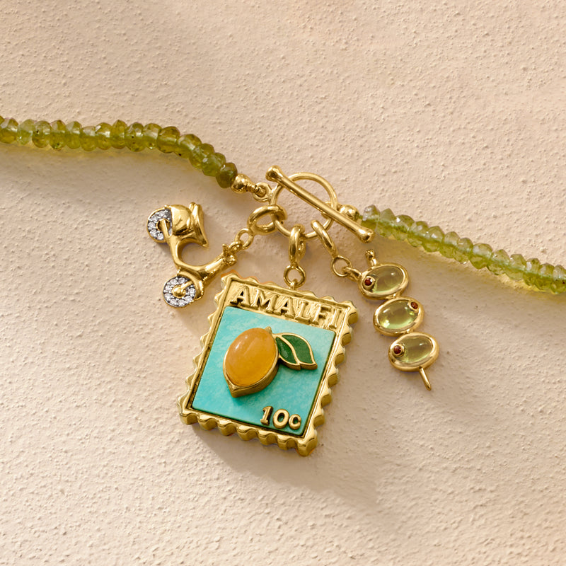 Amalfi enamel charm with turquoise background, gold details, and citrus motif