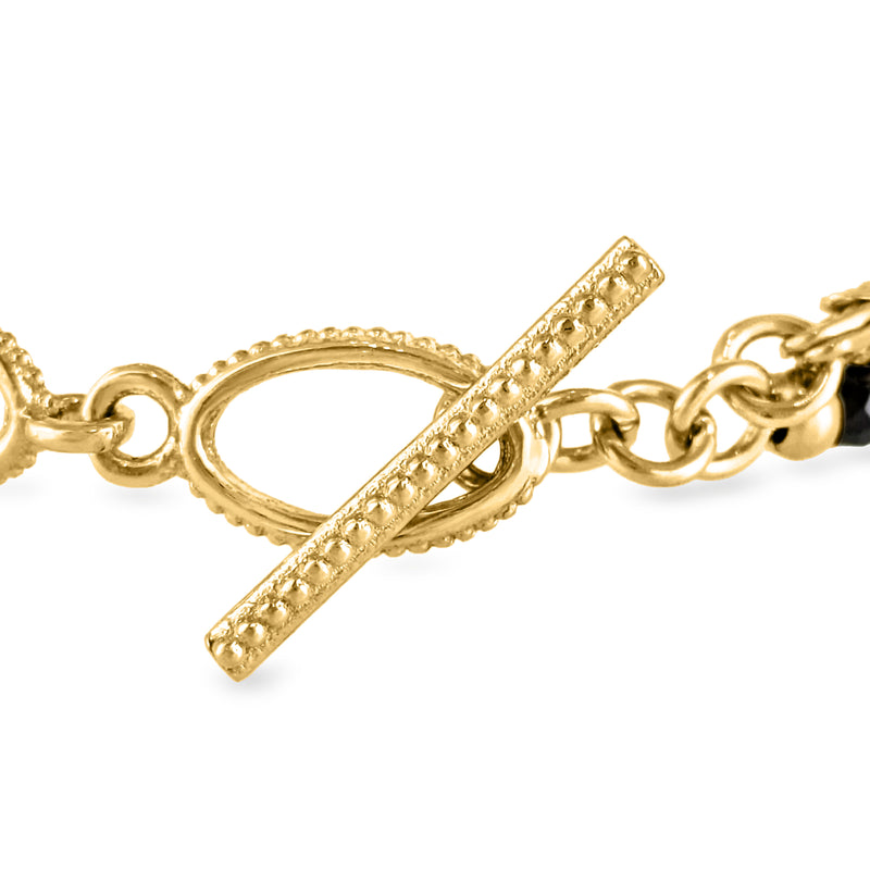 Gold-tone toggle clasp detail with oval ring and bar plus black bead row