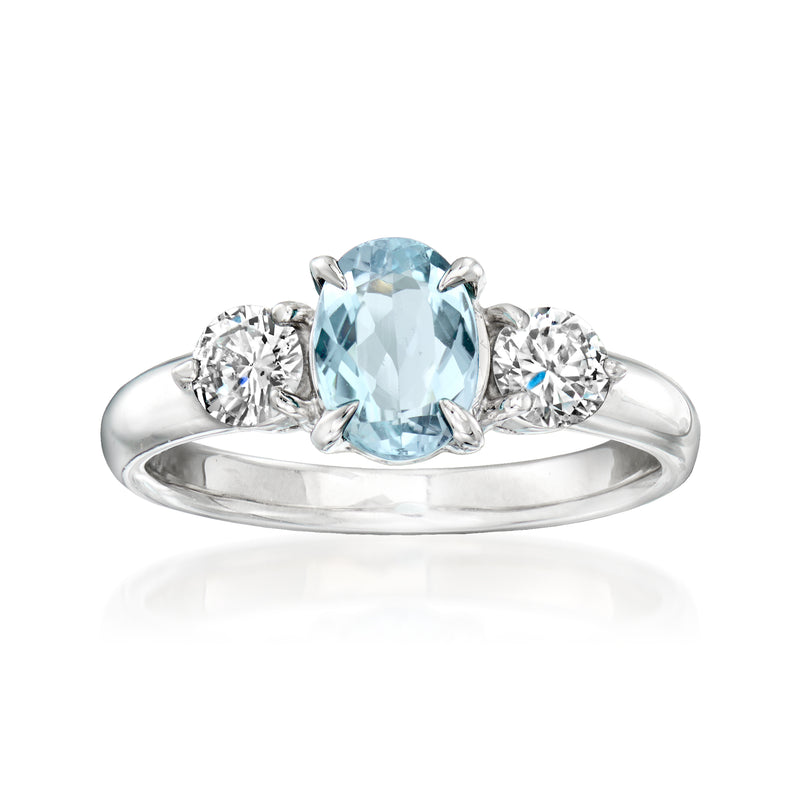 Platinum aquamarine and diamond ring with oval aquamarine center and round diamond side stones