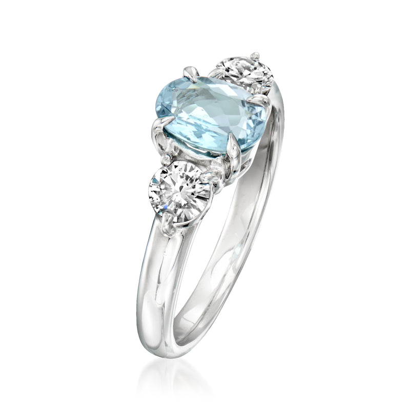 Platinum ring angled view with oval aquamarine center and round diamonds in prong settings