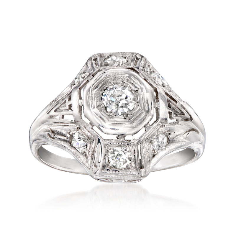 Vintage 18kt white gold diamond cluster ring with oval center stone and side accents