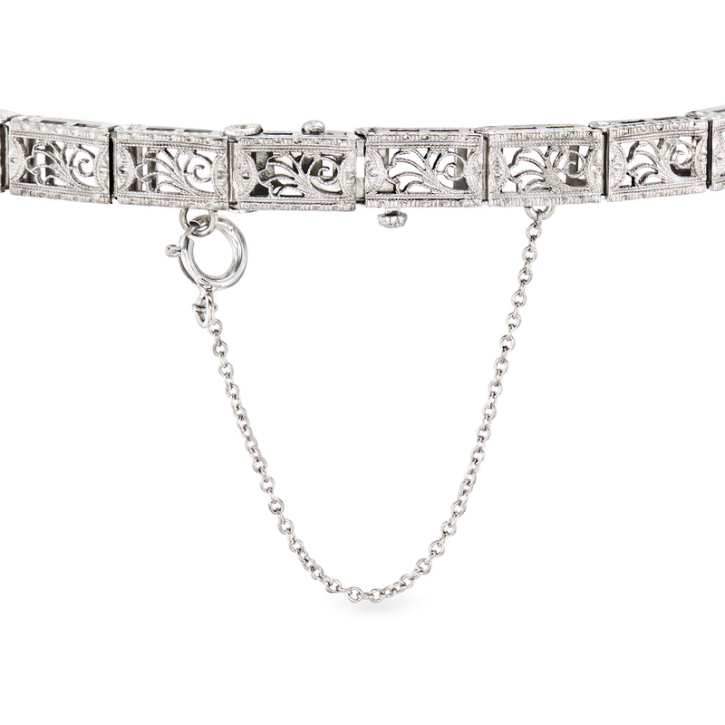 Diamond openwork bracelet with engraved geometric links and dangling chain detail