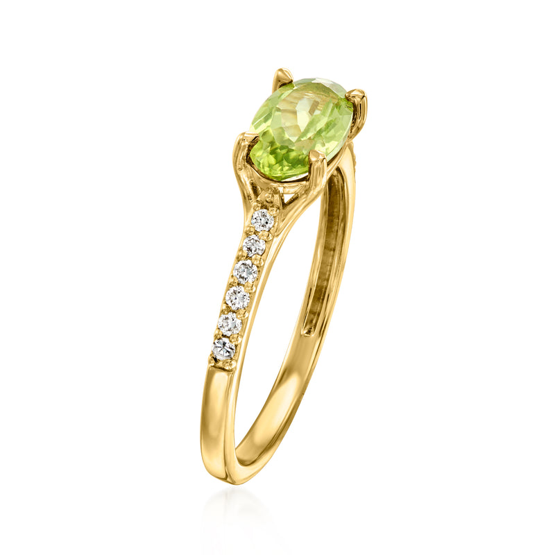 Gold-tone ring with oval green peridot, prong-set; diamond accents on band