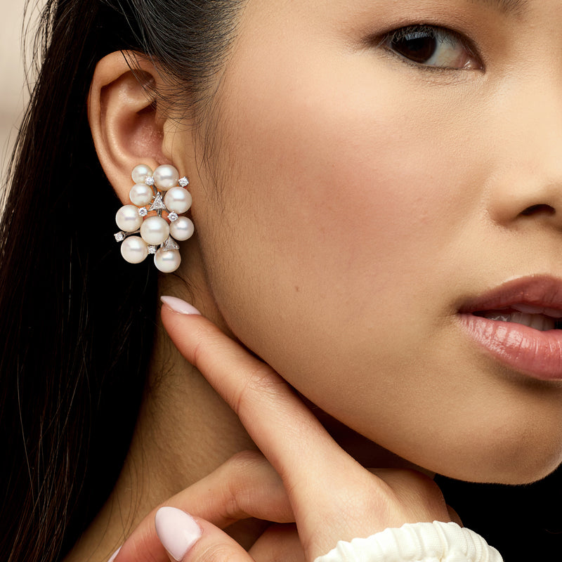 Cultured pearl and diamond clip-on cluster earrings on model, close-up