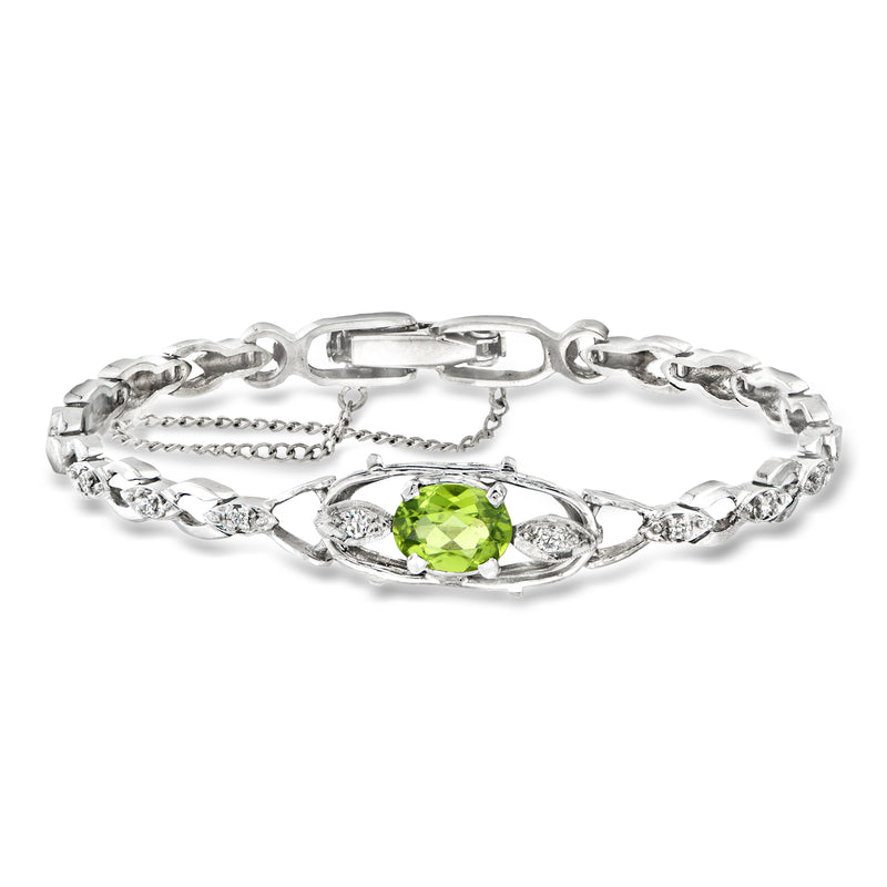 Vintage white gold bracelet with oval green peridot and diamond accents, hinged clasp