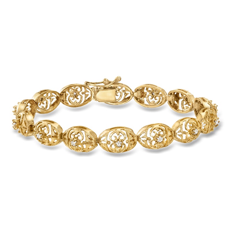 Vintage diamond openwork link bracelet in 14kt yellow gold with oval carved links
