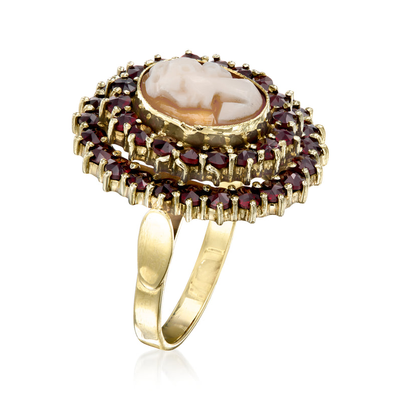 Side view of oval cameo ring in 14kt yellow gold with garnet halo prongs