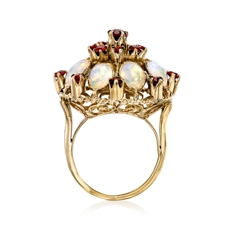 Yellow gold oval cluster ring with white opal stones and red ruby highlights, top view